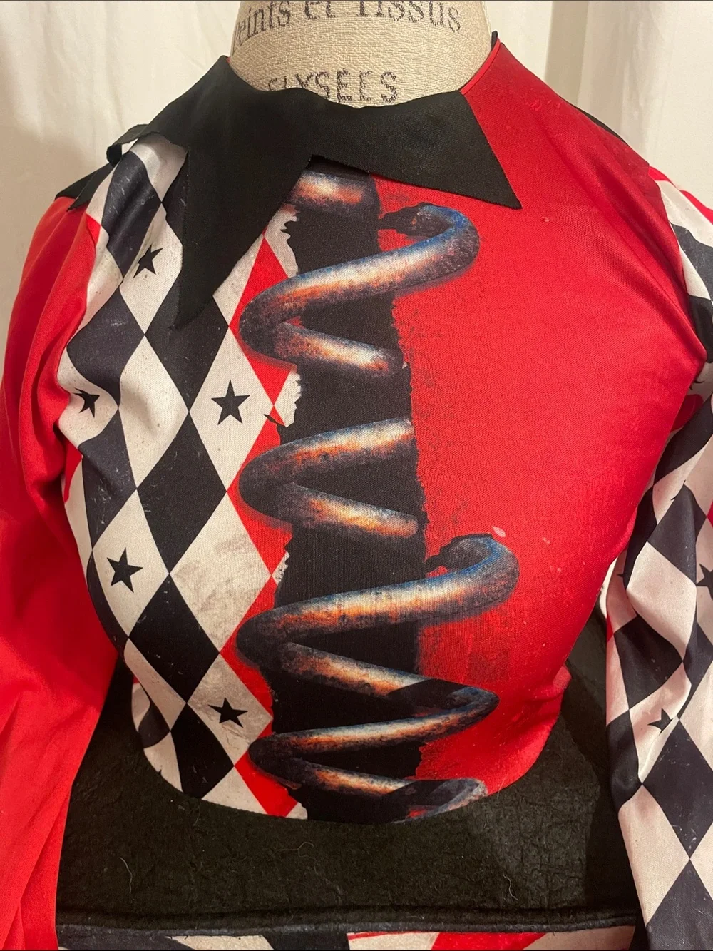 Dirty, scary Jack-in-box Halloween costume or cosplay, including jeweled mask.